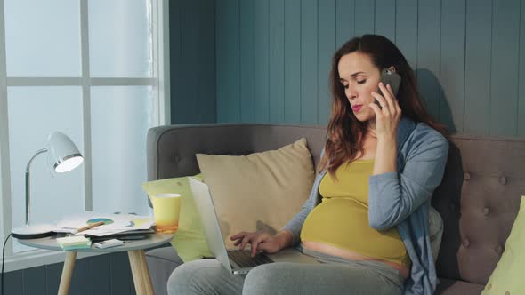 Serious Pregnant Businesswoman Talking Mobile Phone at Home Office.