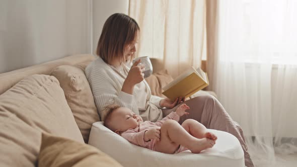Mother of Baby Girl Reading at Home