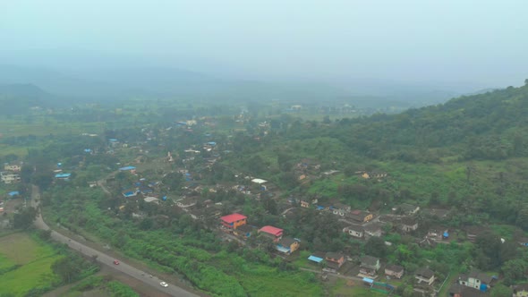 rotating drone shot over rural Indian village on hillside