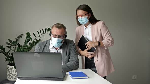 Office Work During the Covid-19 Epidemic. Two Colleagues Avoid a Handshake When Meeting in the