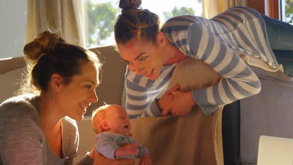 Lesbian couple playing with their baby boy 4k