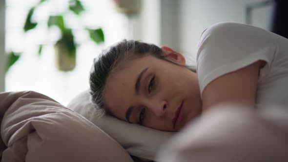 Close up video of depressed woman lying in bed. Shot with RED helium camera in 8K.