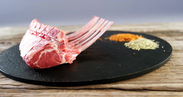 Raw beef ribs and ingredients on wooden board