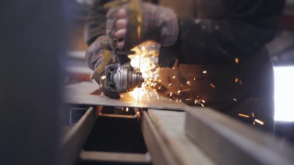 Closeup of Cutting a Metal Sheet with a Grinder in the Workshop