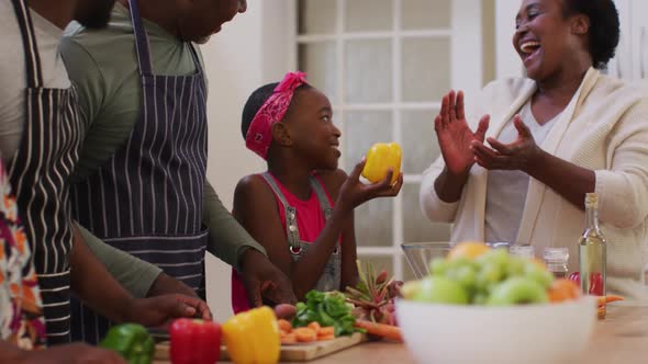 Three generation african american family smiling together in the kitchen at home