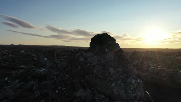 Drone Flight Arcing Around Sunlit Rocks