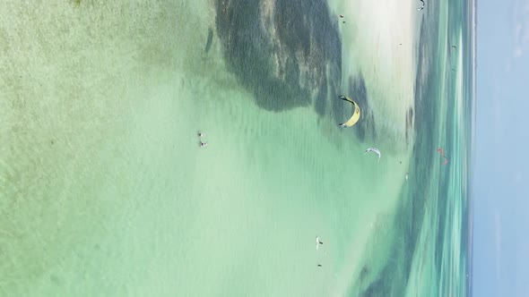 Vertical Video Kitesurfing Near the Shore of Zanzibar Tanzania Aerial View