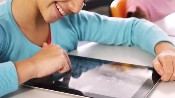 Girl using digital tablet in classroom