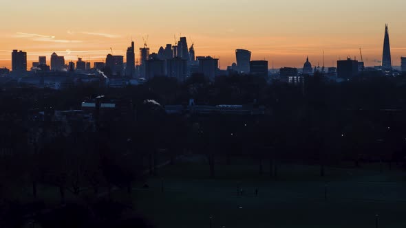 London skyline at sunrise from Primrose Hill in Regents Park. Famous landmarks include the St Paul's