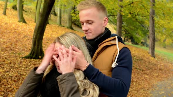 Man Surprises Woman - Young Model Couple in Love - Autumn Park(nature)