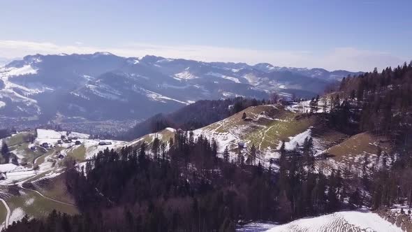 Straight flight over hills and trees in Switzerland