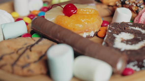 A Sweets and Colorful Candy are Rotating on the Plate