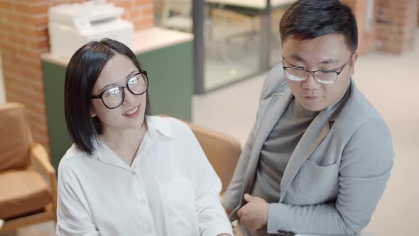 Pair of Asian Students Having Chat