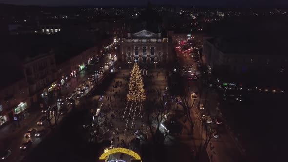 Arial View of Lviv Christmas Tree Near Opera House Festive Lights and Fair Market on Winter Night