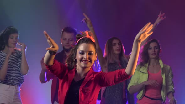 Party Flythrough Shot of Group of People and Friends Dancing To Cool Music with Disco Lights . Smoke