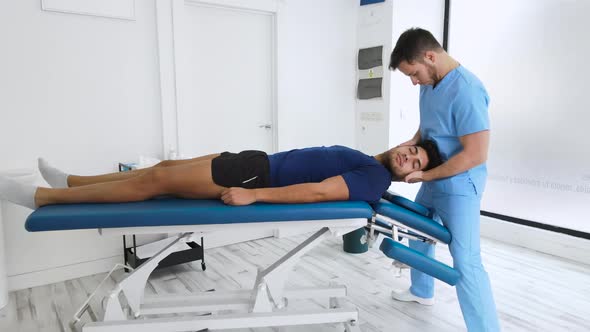 Physiotherapist Massaging the Neck of a Young Patient Zoom in Smooth Dolly Shot