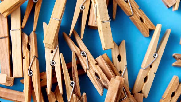 Close Up of Wooden Clothespins on Blue Background