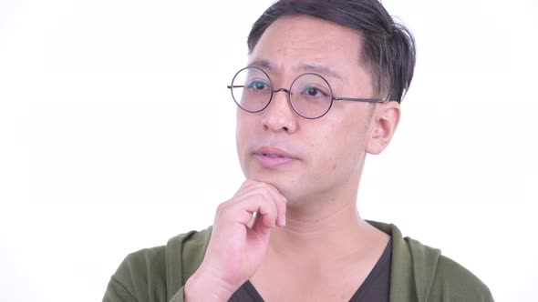 Face of Happy Japanese Man with Eyeglasses Thinking and Looking Up