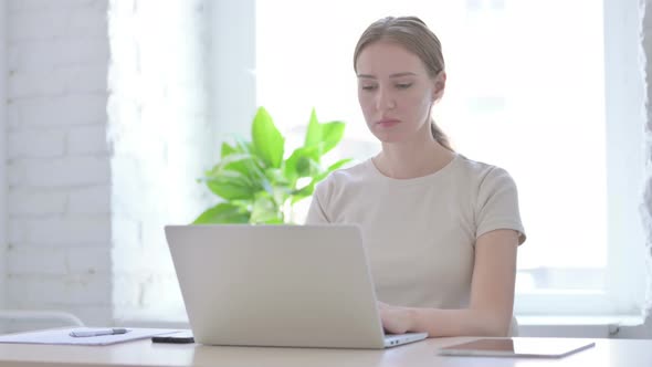 Woman Having Neck Pain While Using Laptop