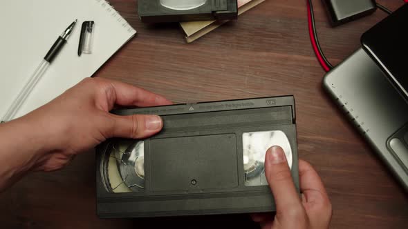 Hands Holding Old Video Cassette Closeup