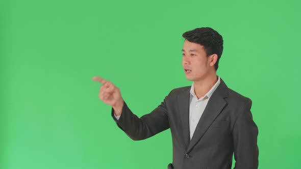 Asian Business Man Threatening With Finger In The Green Screen Studio