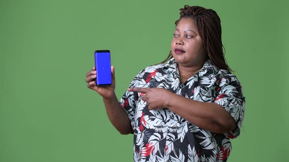 Overweight Beautiful African Woman Against Green Background