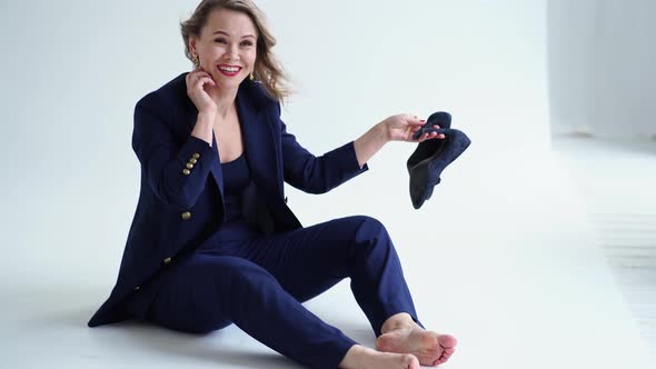 Woman Barefoot in Blue Suit on in Photo Studio