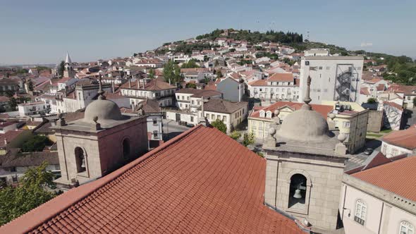 Aerial backwards view of rooftops in scenic Castelo Branco, Portugal.