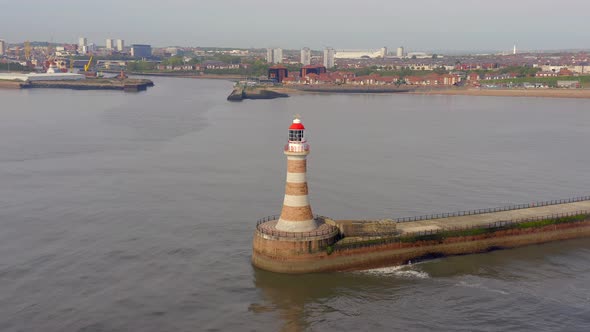 A Lighthouse and Pier in the Early Morning