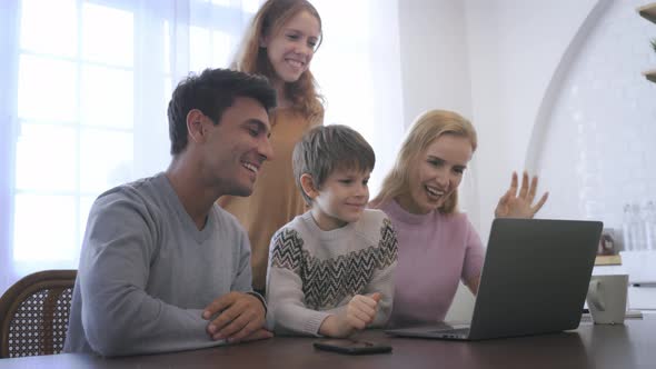 Young Family Using Laptop at Home