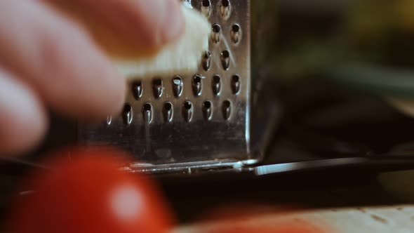 Grated Cheese on a Table Full of Vegetables