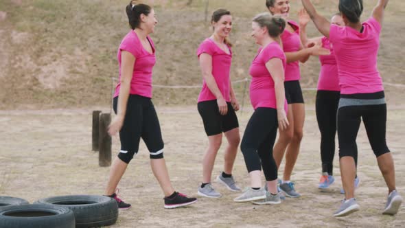 Female friends enjoying exercising at boot camp together