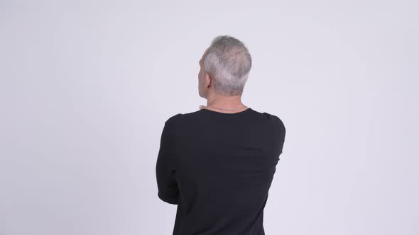 Rear View of Persian Man Pointing Finger Against White Background