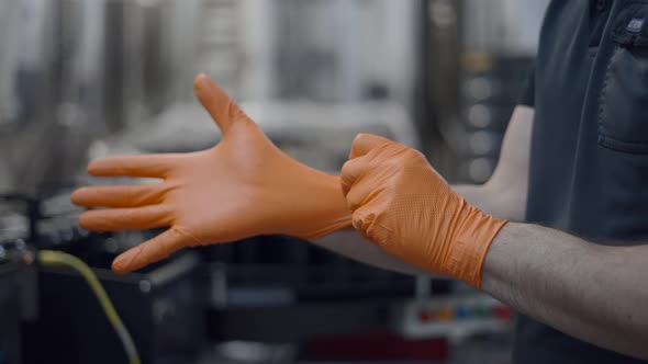 Worker Wearing Rubber Gloves In Modern Beer Factory  Close Up