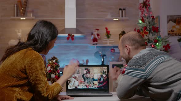 Couple Using Video Call Talking to Family on Christmas Eve
