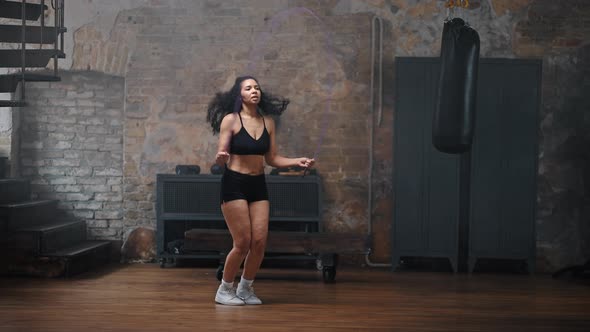 Sportive African American Woman Enjoys Jump Rope Workout