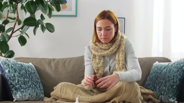 Sick Woman in Scarf Drinking Cough Syrup at Home