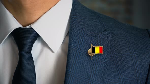 Businessman Walking Towards Camera With Country Flag Pin Belgium