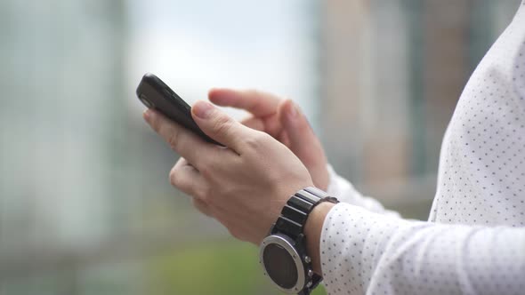 Closeup of a Businessman with a Phone and Negative Emotions in It