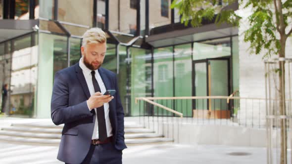 Confident businessman in front of modern office building. Financial investor outdoor.