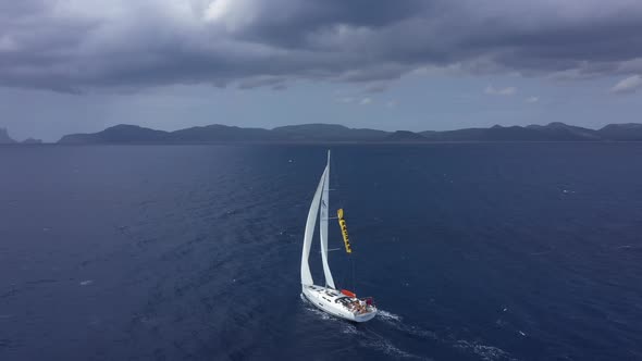 Yacht Sailing at Sunset During a Storm