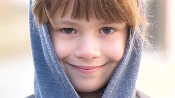 Portrait of Happy Child Girl in Warm Clothes in Autumn Outdoors