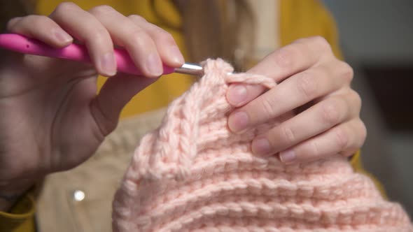 Closeup of Young Female Hands of a Caucasian Girl Doing Crochet Shows How to Knit Correctly