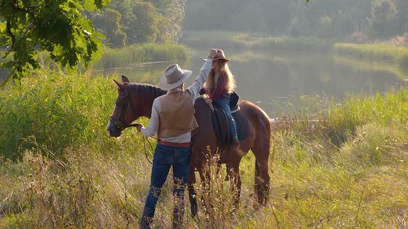 Cowboy and His Daughter on Horseback