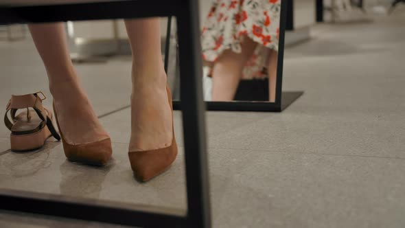 Young Female Tries on Shoes in the Clothing Store Behind the Mirror and Swirling