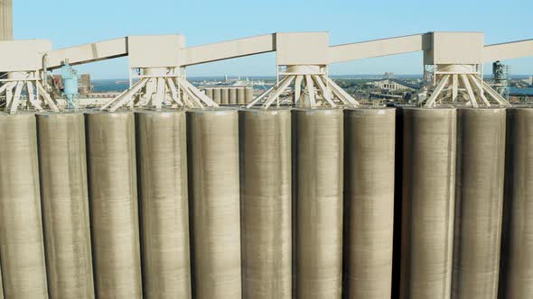 Aerial view rows of tall concrete grain storage silos in Duluth Minnesota - drone tracking day