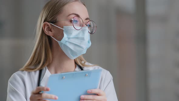 Portrait Caucasian Woman Doctor Nurse in Medical Protective Mask Writing Information in Medical