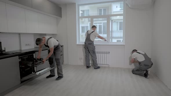 Workers Make Repairs in a New Apartmen