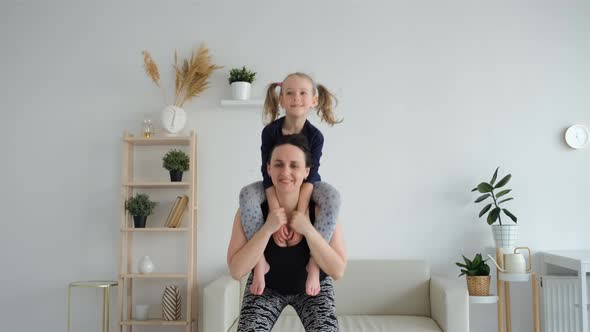Mother with Little Daughter Exercising at Home