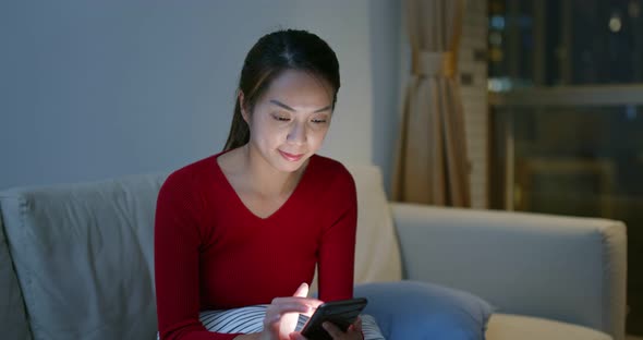 Woman use of smart phone at night